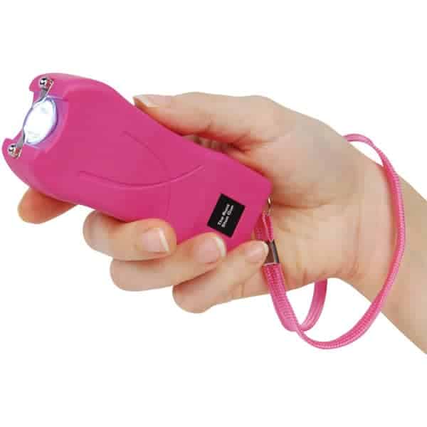 Pink Runt Rechargeable Stun Gun With Flashlight And Wrist Strap Disable Pin Shown in Hand | Advanced Safety Tech Pink Runt Rechargeable Stun Gun with Flashlight and Wrist Strap Disable Pin Shown in Hand Advanced Safety Tech Pink Runt Rechargeable Stun Gun with Flashlight and Wrist Strap Disable Pin Shown in Hand